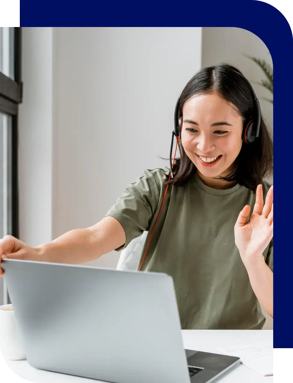 woman smiling looking at her computer